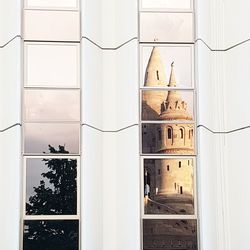 Exterior of historic building seen through glass window