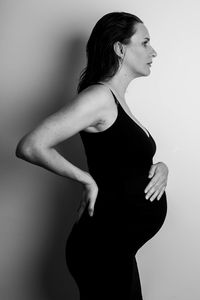 Side view of young woman against white background