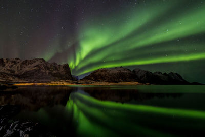 Scenic view of lake against sky at night