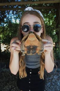 Close-up portrait of young woman wearing sunglasses