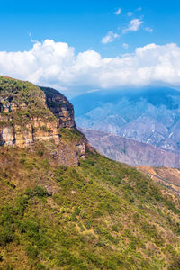 Scenic view of mountains against cloudy sky