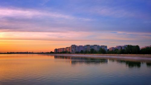 Scenic view of lake against sky during sunset