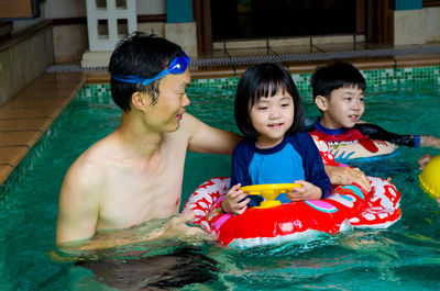 Happy family in swimming pool