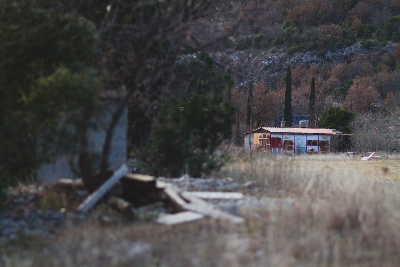 ABANDONED BUILT STRUCTURE IN GRASS