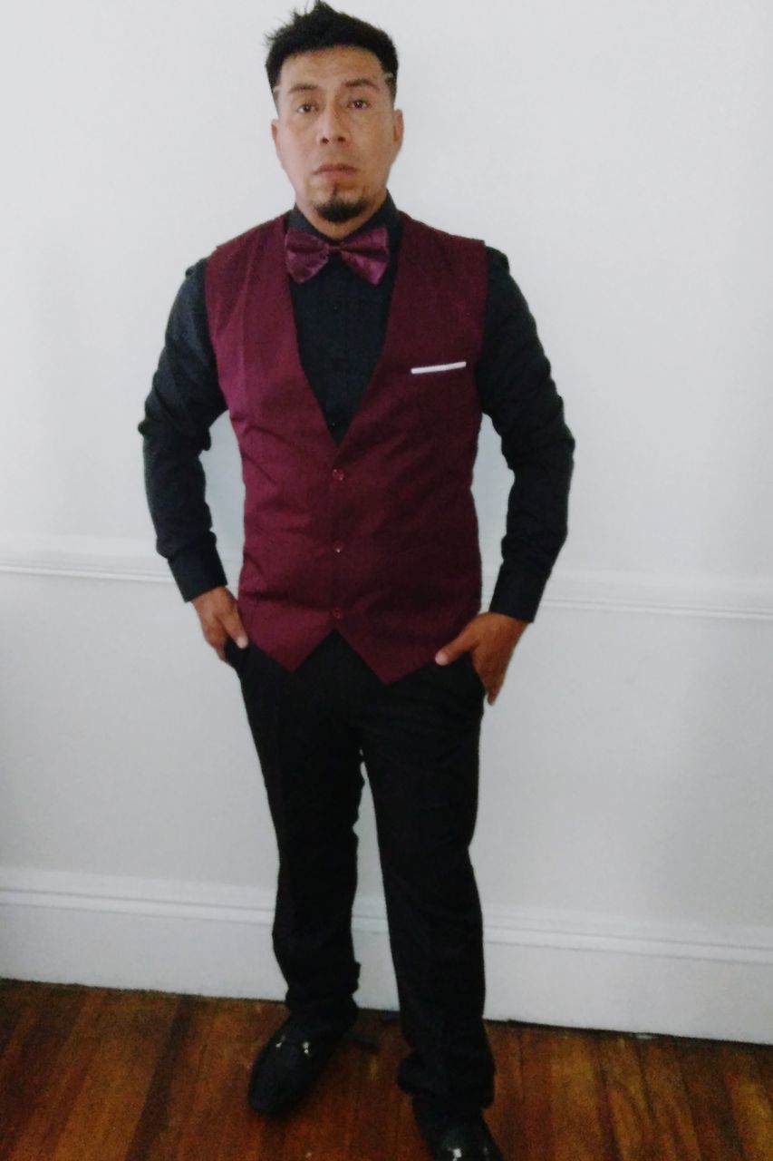 one person, standing, portrait, indoors, looking at camera, full length, adult, front view, men, clothing, young adult, hands in pockets, serious, fashion, formal wear, wood, outerwear, hardwood floor, casual clothing, individuality, looking, flooring, lifestyles, footwear, spring, cool attitude