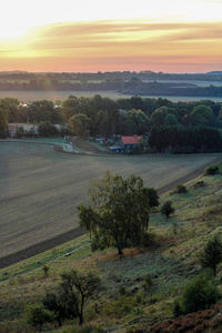 Scenic view of field against sky during sunset