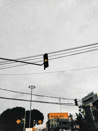 Low angle view of street lights against sky