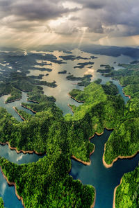 High angle view of river and trees against sky