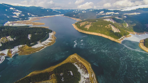 Aerial view of lake and mountains against sky