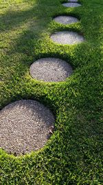 Stepping stones on grassy field