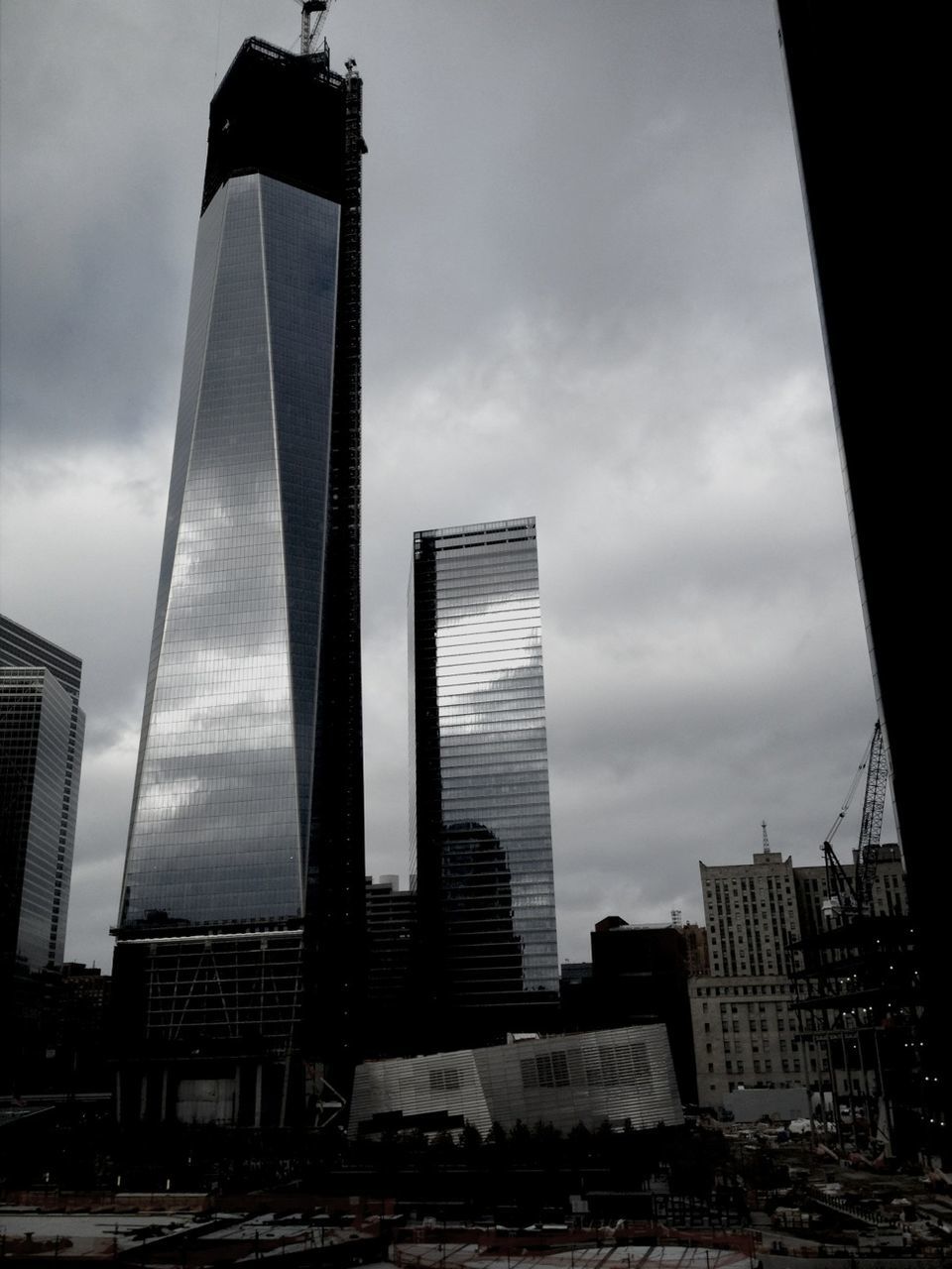 architecture, built structure, building exterior, skyscraper, city, sky, tall - high, modern, tower, office building, low angle view, cloud - sky, building, cloudy, urban skyline, development, tall, outdoors, no people, capital cities