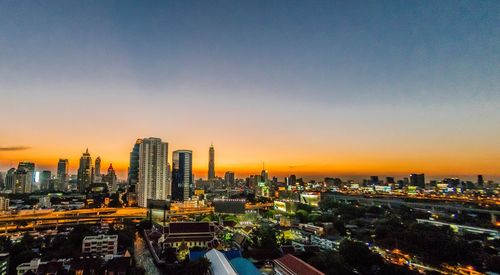 Aerial view of city buildings during sunset