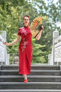 Rear view of woman holding umbrella