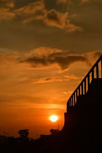 Low angle view of silhouette bridge against sky during sunset