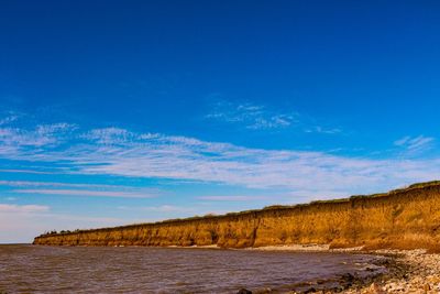 Scenic view of sea against blue sky