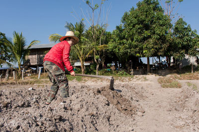 Female farmer wearing hat while working in farm