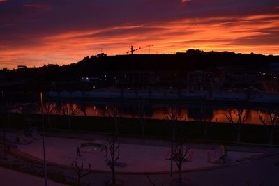 Silhouette buildings against sky during sunset