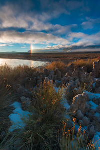 Scenic view of land against sky during sunset