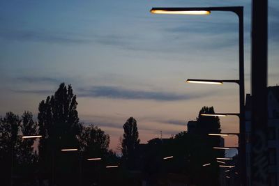 Illuminated city against sky during sunset