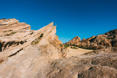 Scenic view of mountains against clear blue sky