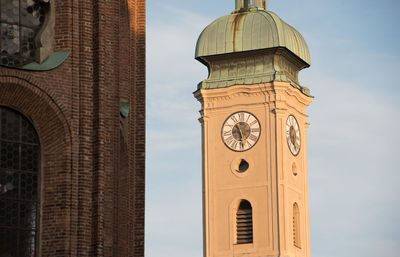 Low angle view of clock tower against sky in city