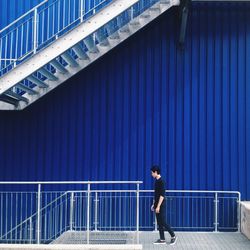 Side view of young man standing on steps