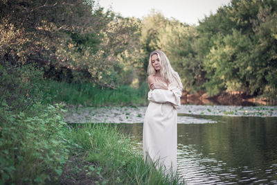 Woman standing at lakeshore