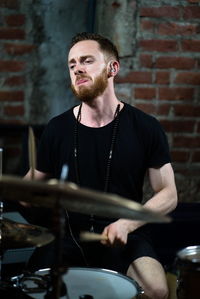 Young man sitting on stage
