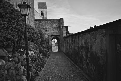 Narrow alley amidst buildings against sky