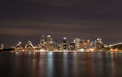 Illuminated city at waterfront