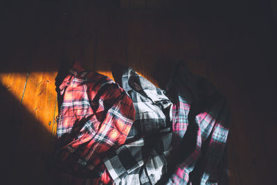 High angle view of shirts on hardwood floor