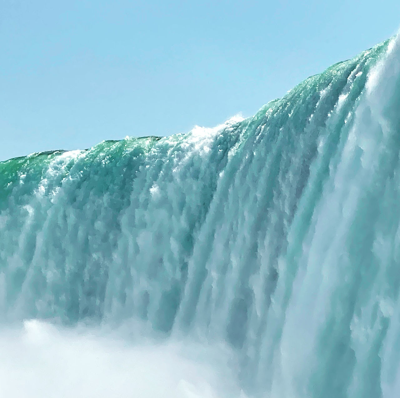 LOW ANGLE VIEW OF WATER FLOWING AGAINST SKY