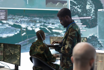 Side view of man using mobile phone
