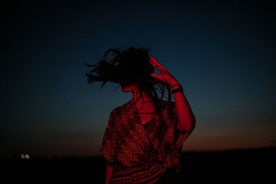 Rear view of woman standing against sky