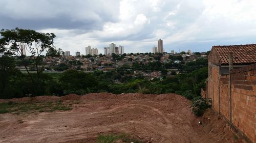 Buildings against cloudy sky