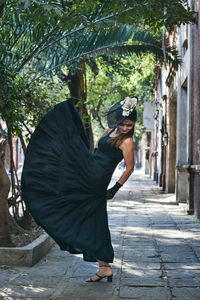 Side view of a woman walking on footpath