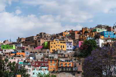 Buildings in city against sky