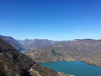 Scenic view of mountains against clear blue sky