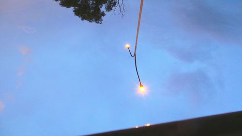 Low angle view of street light against blue sky