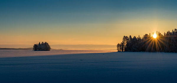 Scenic view of frozen sea during sunset