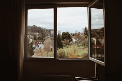 Trees and houses seen through window