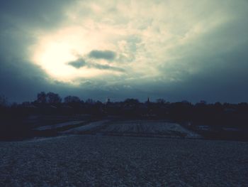 Scenic view of field against sky at sunset