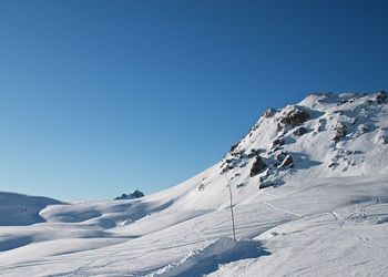 Scenic view of snowcapped mountain against cloudy sky