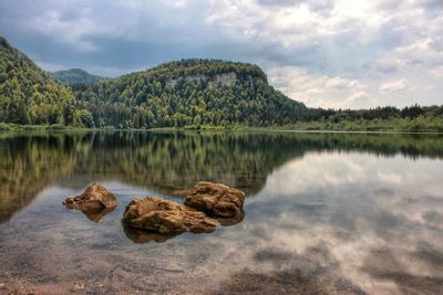 Scenic view of lake and mountains against sky