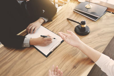 High angle view of people sitting on table
