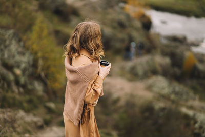 Rear view of woman standing outdoors