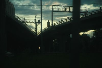 Silhouette bridge against sky at sunset