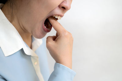 Close-up of woman hand over white background