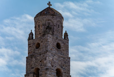 Low angle view of bell tower against sky