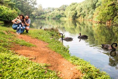 People sitting by lake